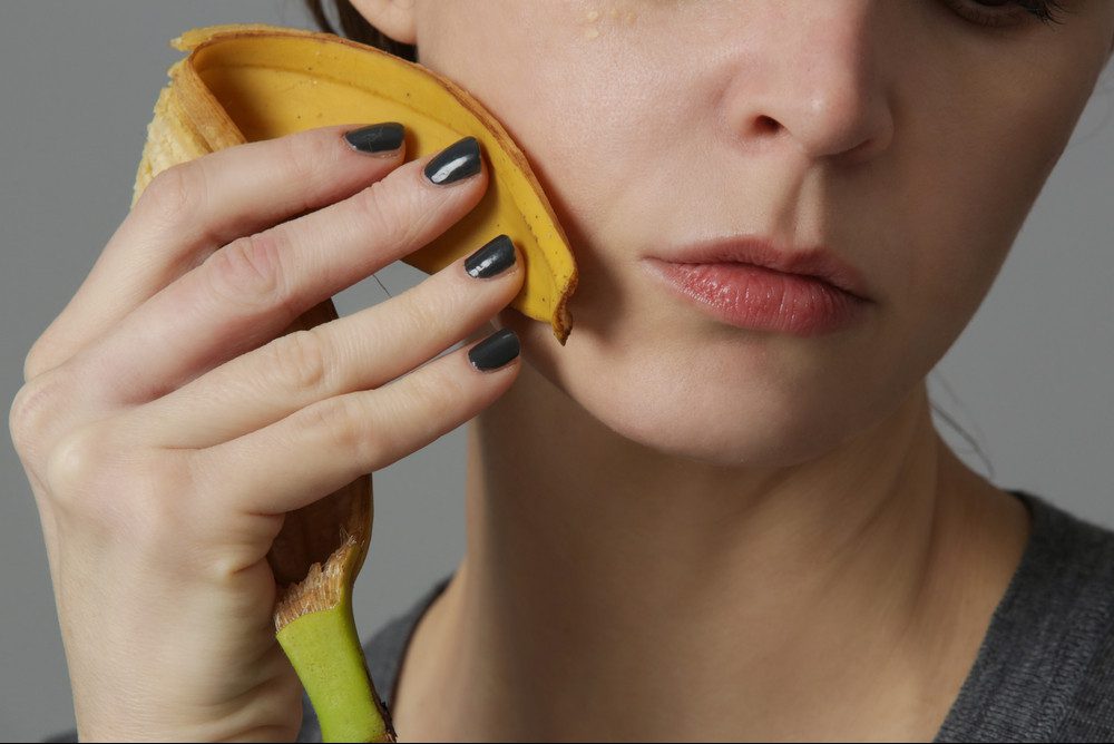 lady using banana peel on her face