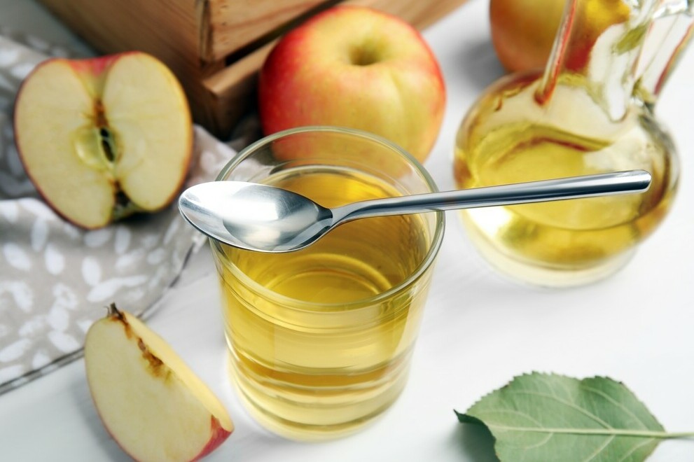 glass of apple cider vinegar with spoon